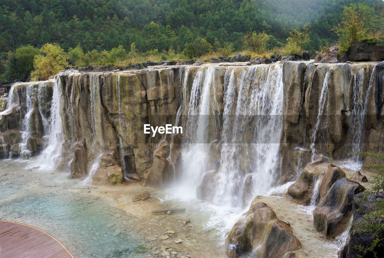 VIEW OF WATERFALL IN FOREST