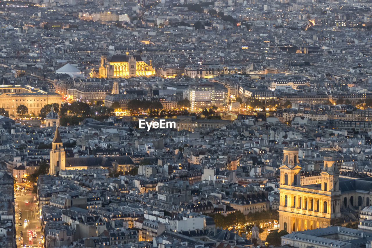Aerial view of paris at dusk with the city illuminated