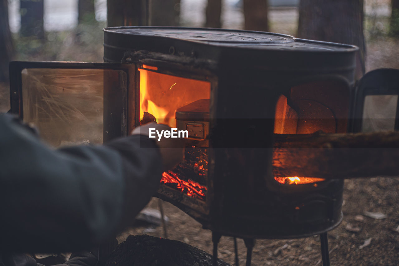 Campsite in winter. smoking food over an open fire in a wood stove outdoors.