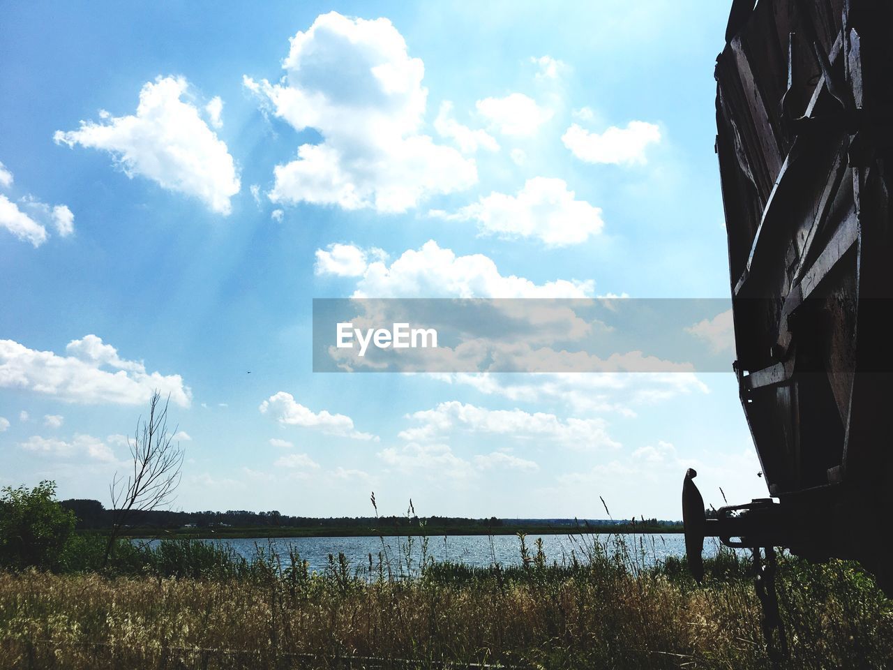 VIEW OF LAKE AGAINST CLOUDY SKY