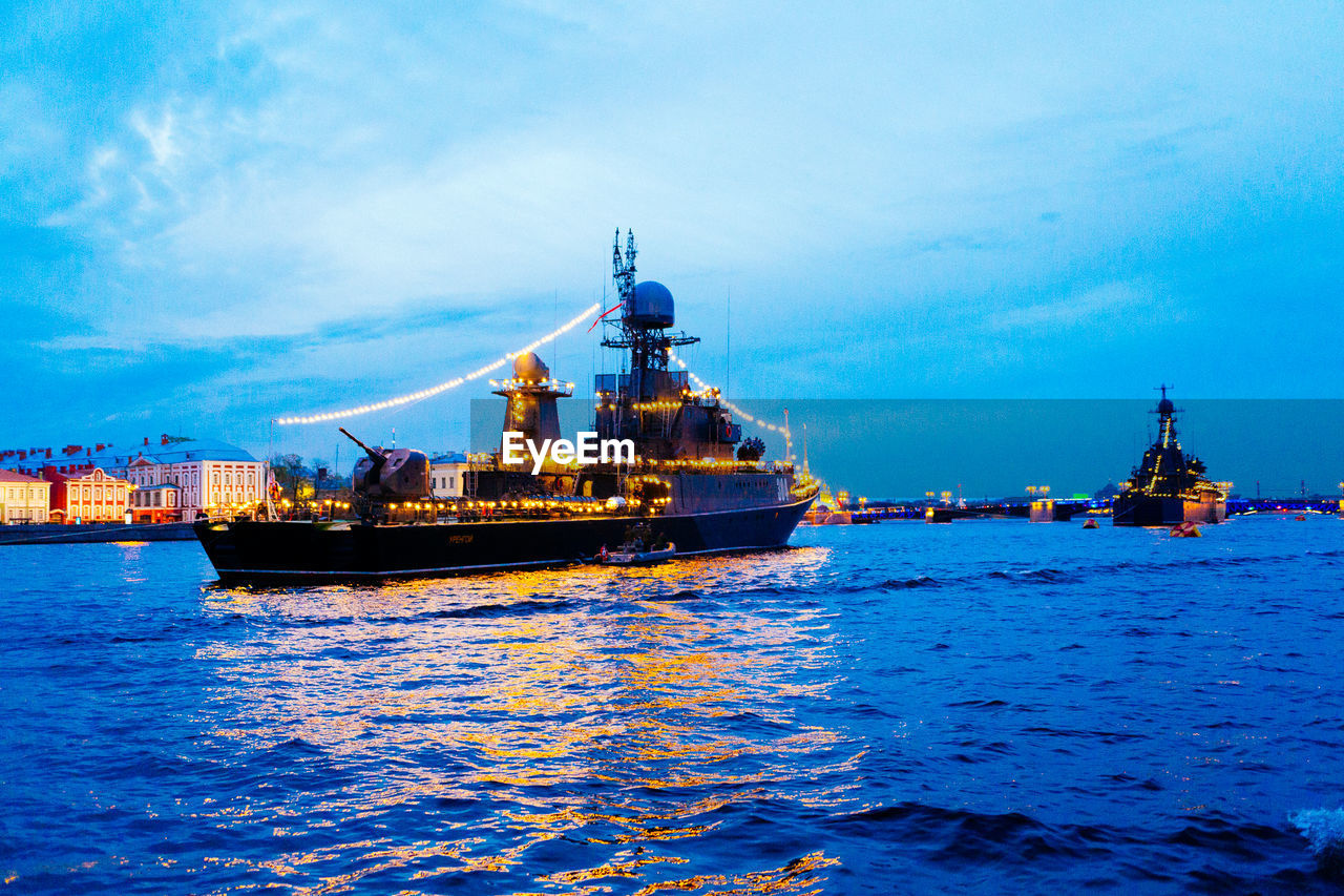 CALM SEA WITH BUILDINGS IN BACKGROUND