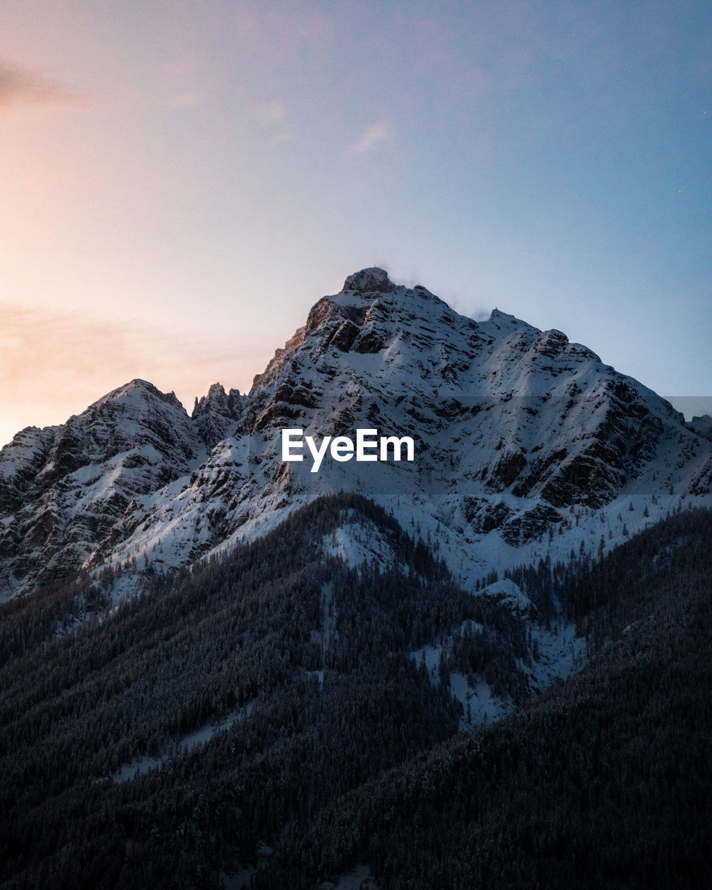 Scenic view of snowcapped mountains against sky during sunset