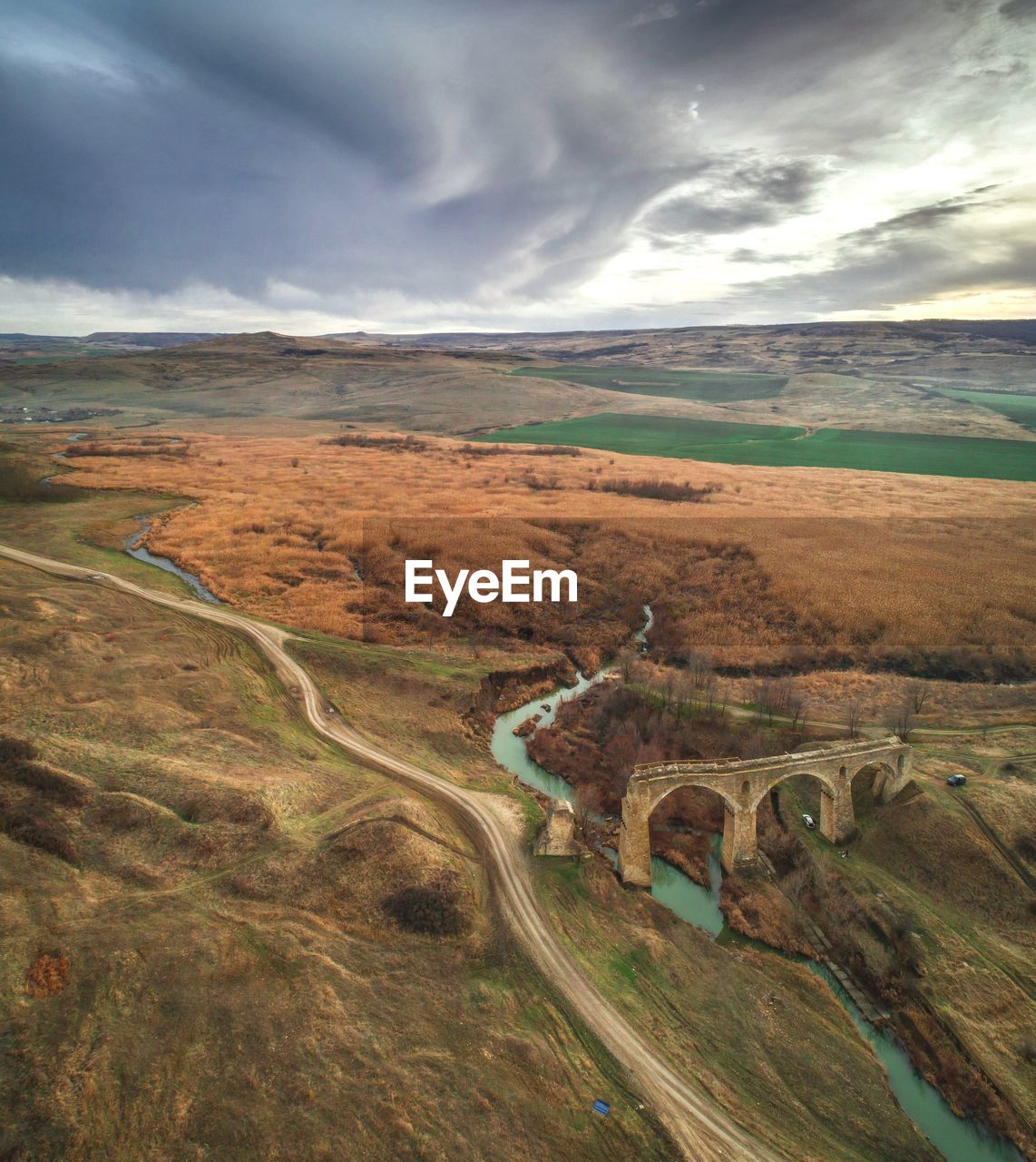 High angle view of road by land against sky