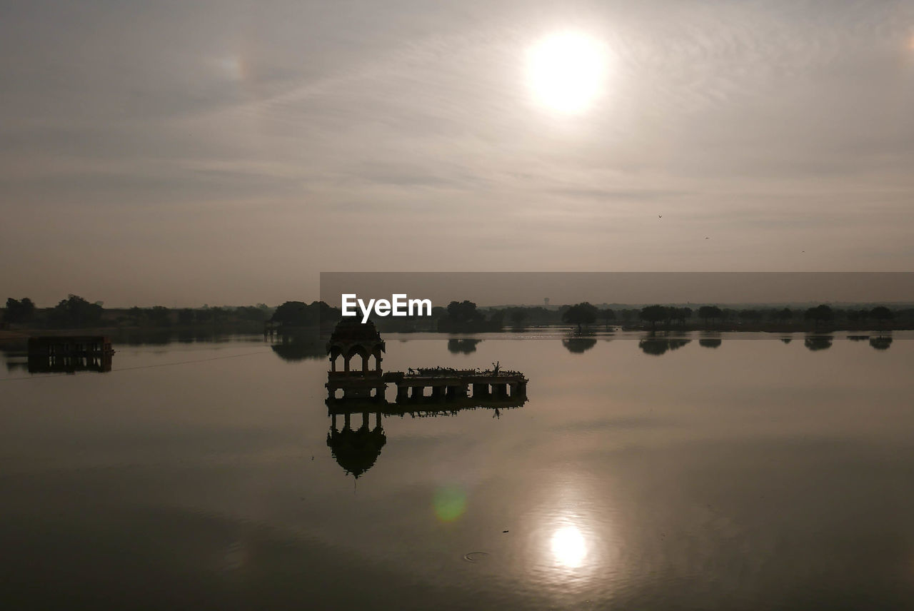 Scenic view of lake against sky during sunset