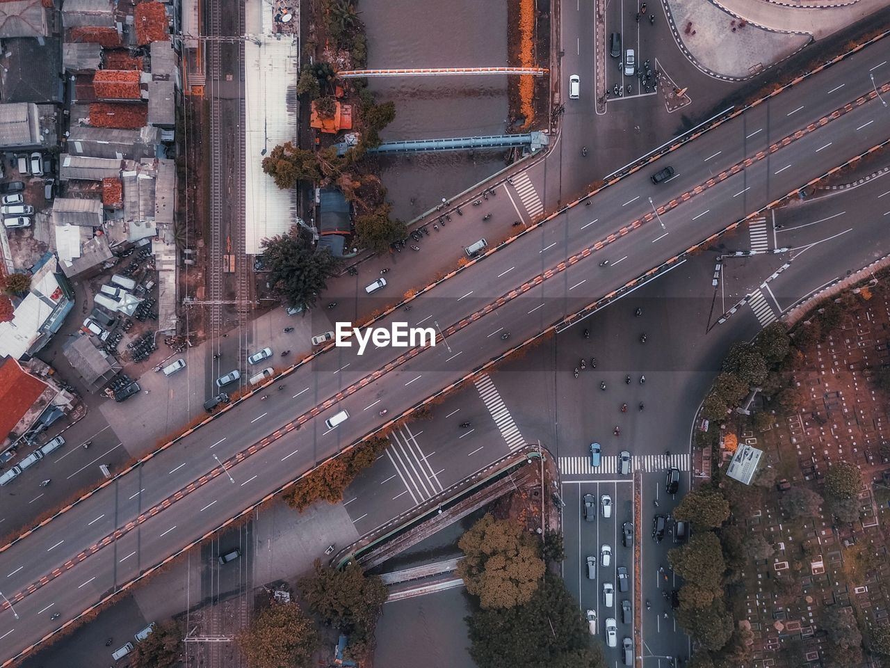 Aerial view of cars moving on bridge in city