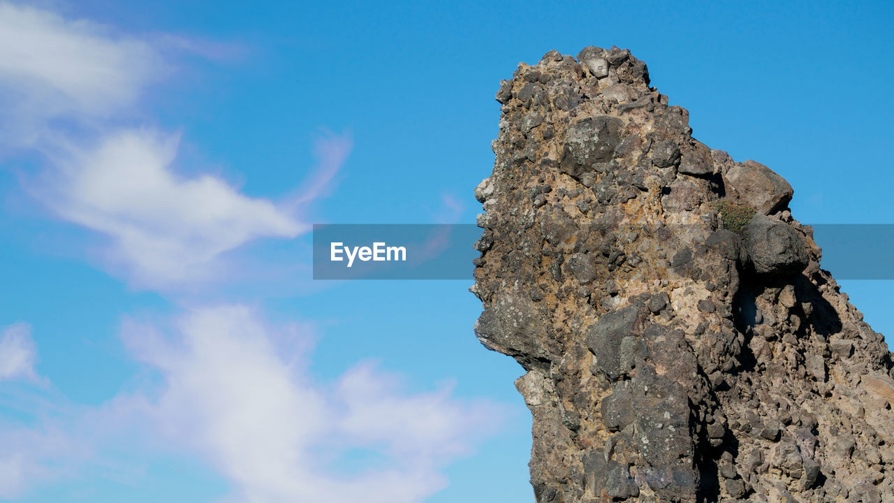 LOW ANGLE VIEW OF ROCK FORMATIONS AGAINST SKY