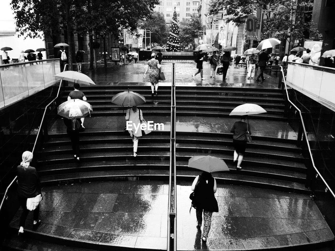 High angle view of people moving up on steps during monsoon