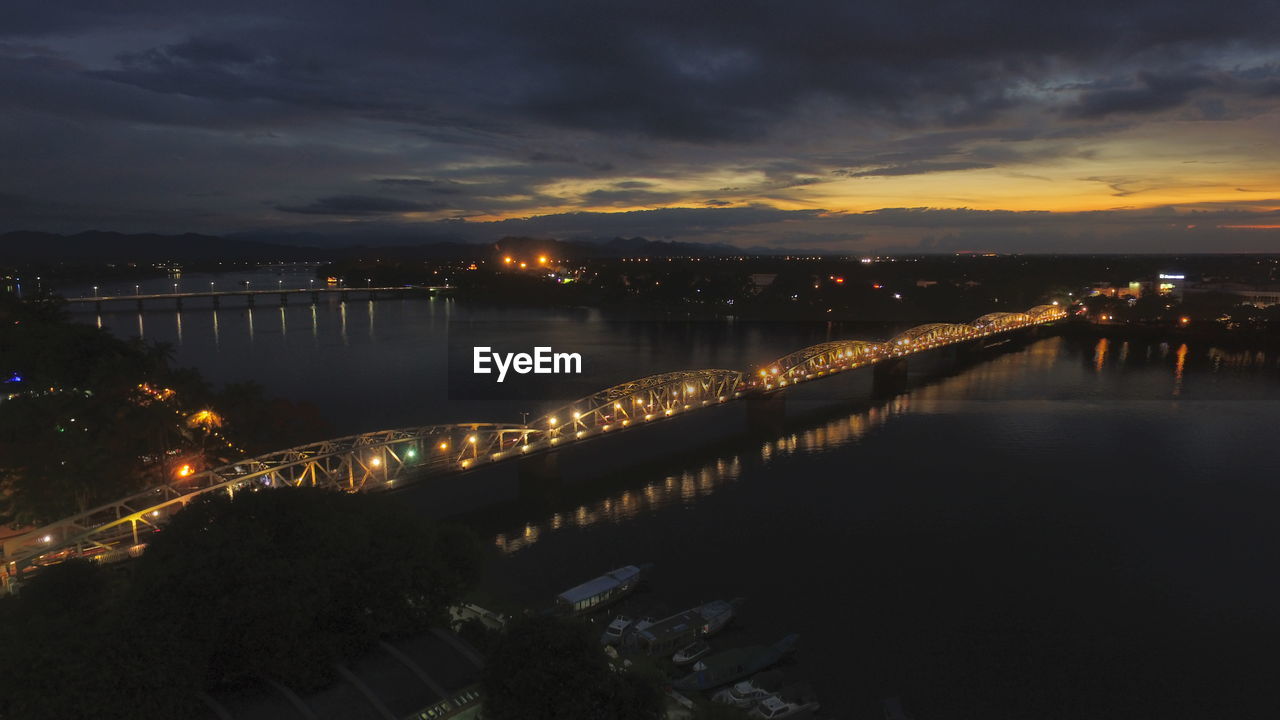 ILLUMINATED CITY AT RIVERBANK