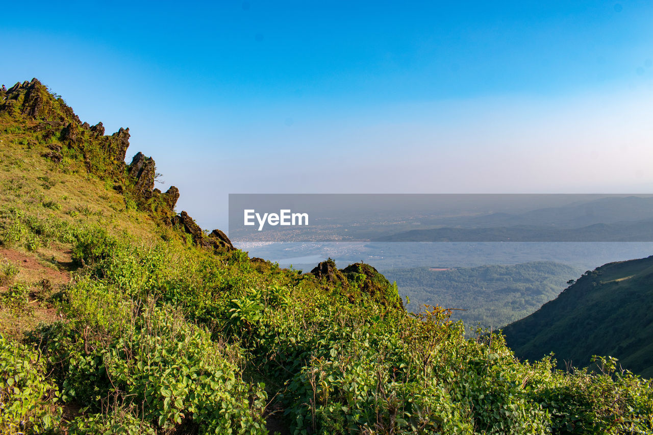 environment, nature, landscape, sky, mountain, scenics - nature, land, beauty in nature, travel, wilderness, plant, travel destinations, mountain range, ridge, tree, tourism, tranquility, outdoors, blue, no people, forest, cloud, non-urban scene, tranquil scene, valley, panoramic, adventure, rock, sunlight, rural scene, summer, architecture, trip, mountain peak, plateau, vacation, activity, idyllic, social issues, clear sky, sunset, cliff, water, holiday, horizon, environmental conservation, autumn, sea, sunny