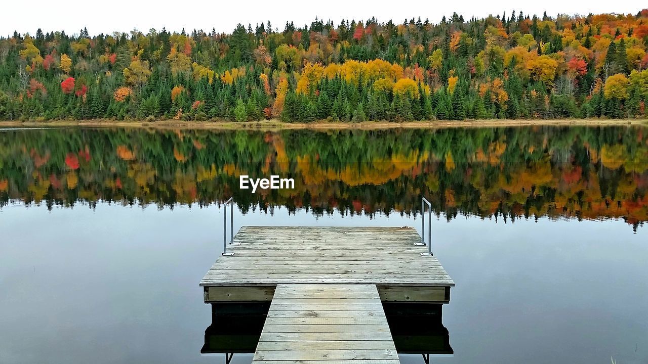 Wood dock on a calm lake in autumn 