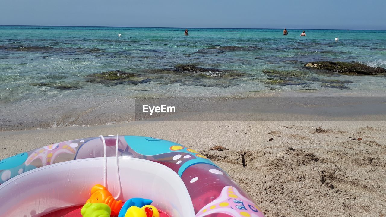 SCENIC VIEW OF BEACH AGAINST BLUE SKY