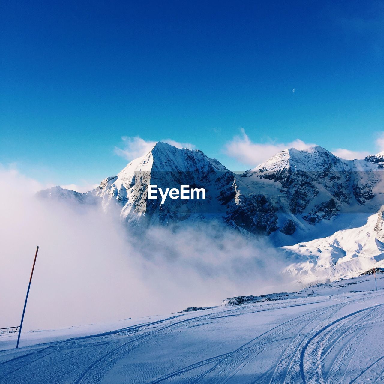 Idyllic shot of snowcapped mountains against blue sky