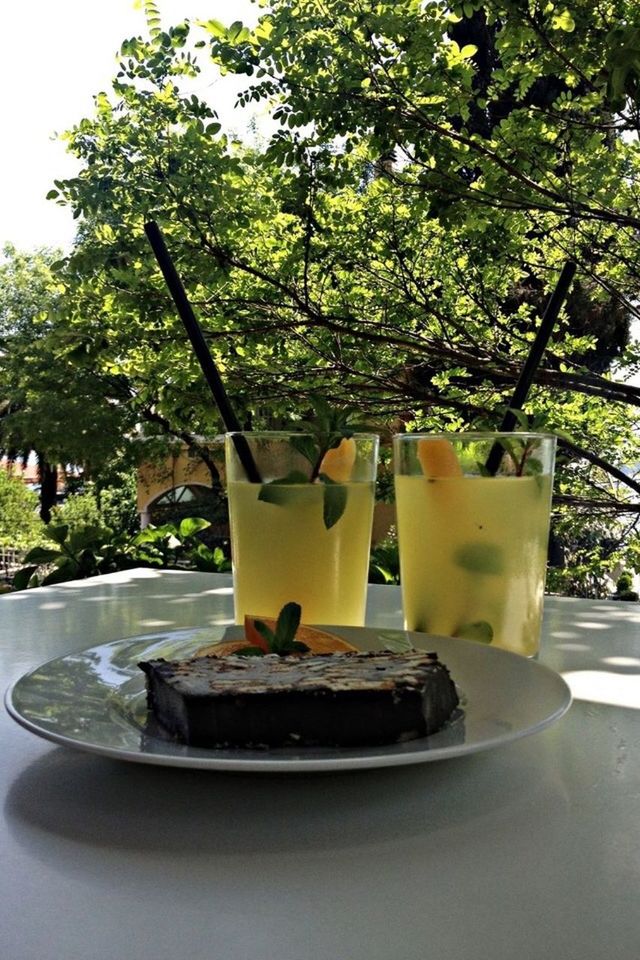 CLOSE-UP OF DRINK ON TREE STUMP