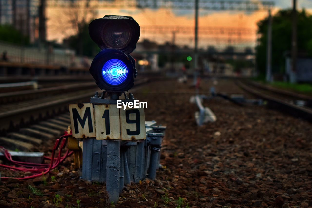 Close-up of illuminated railway signal on track