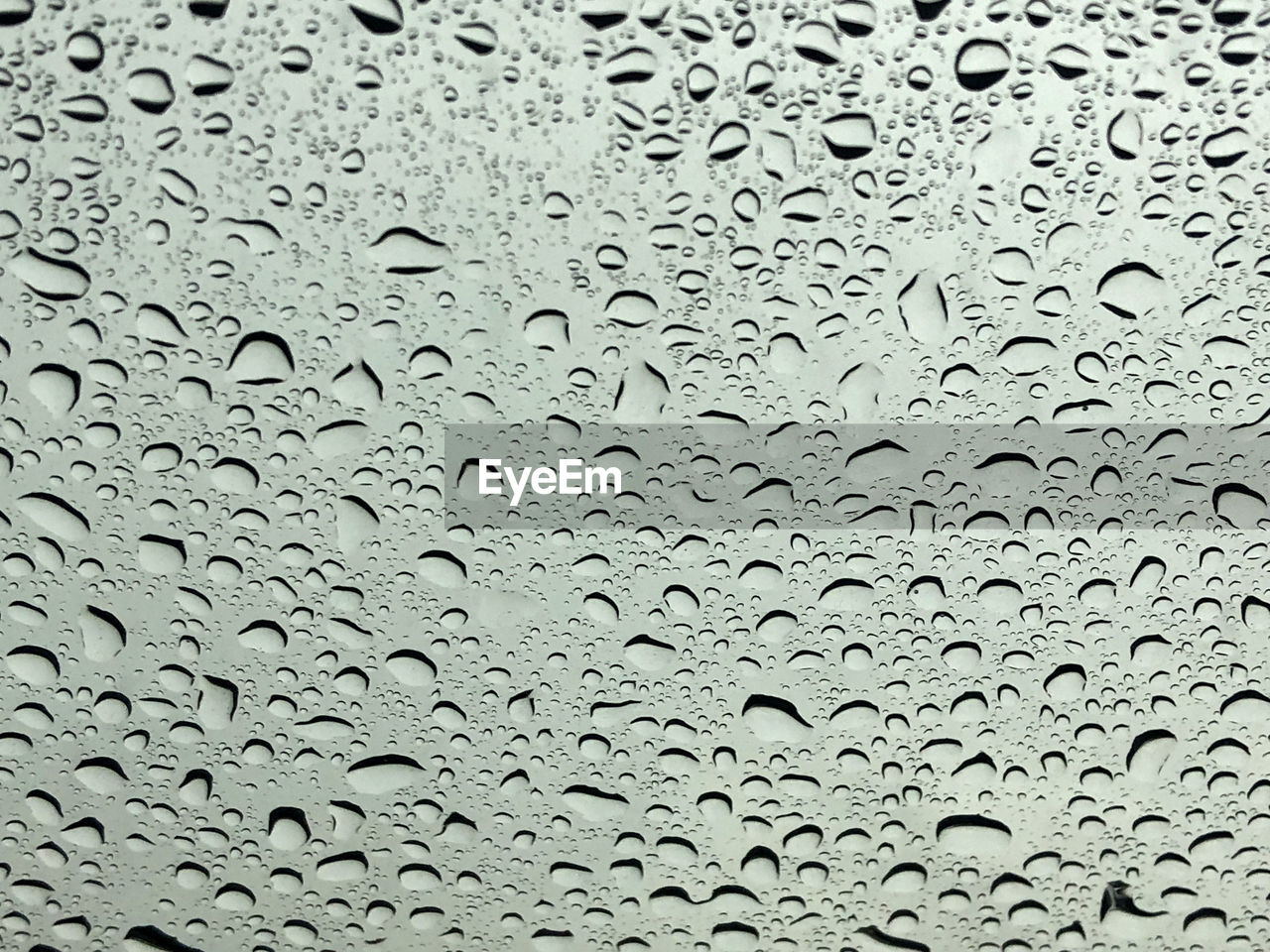 Full frame shot of raindrops on glass window