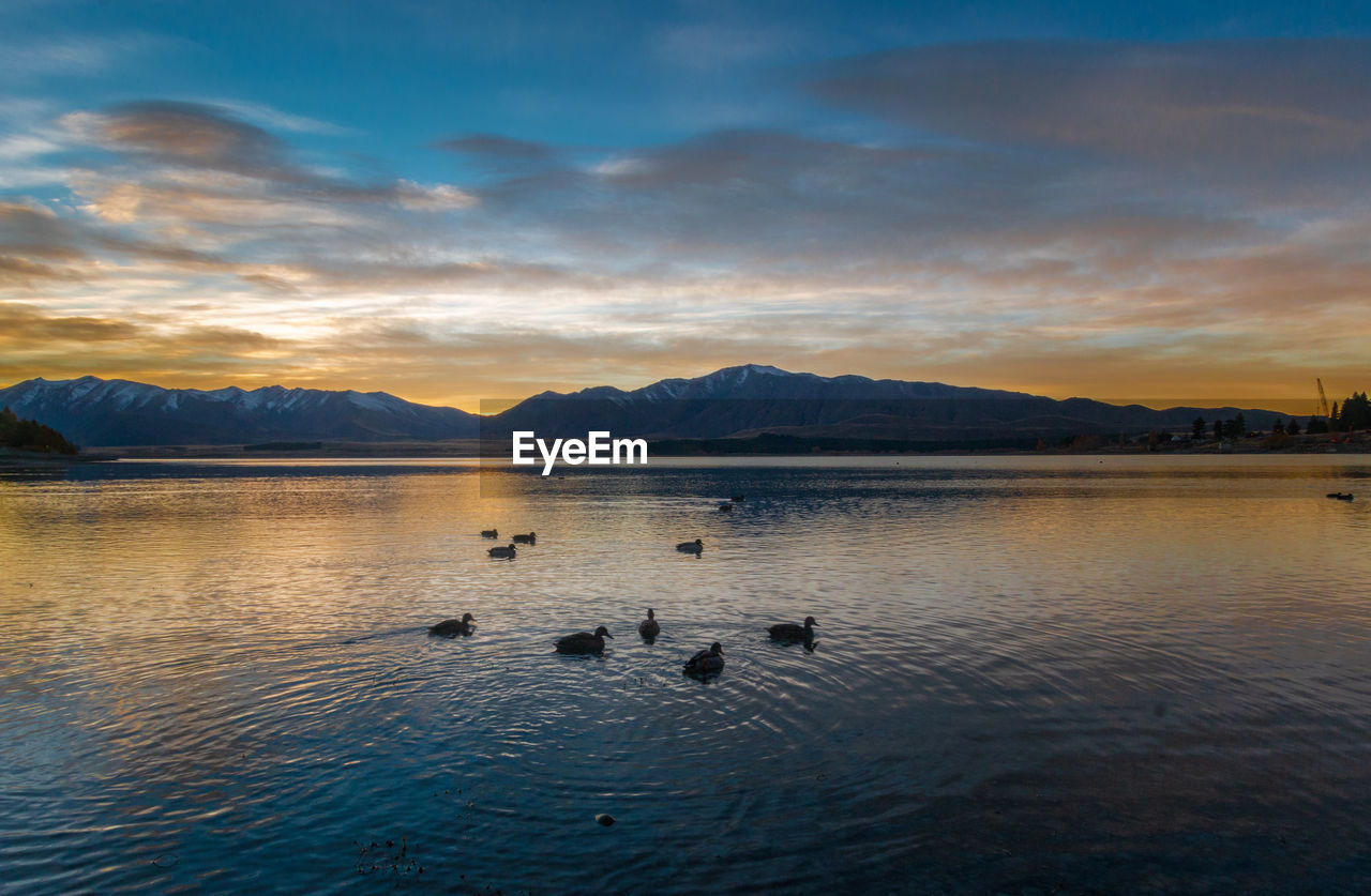 Scenic view of lake against sky during sunrise