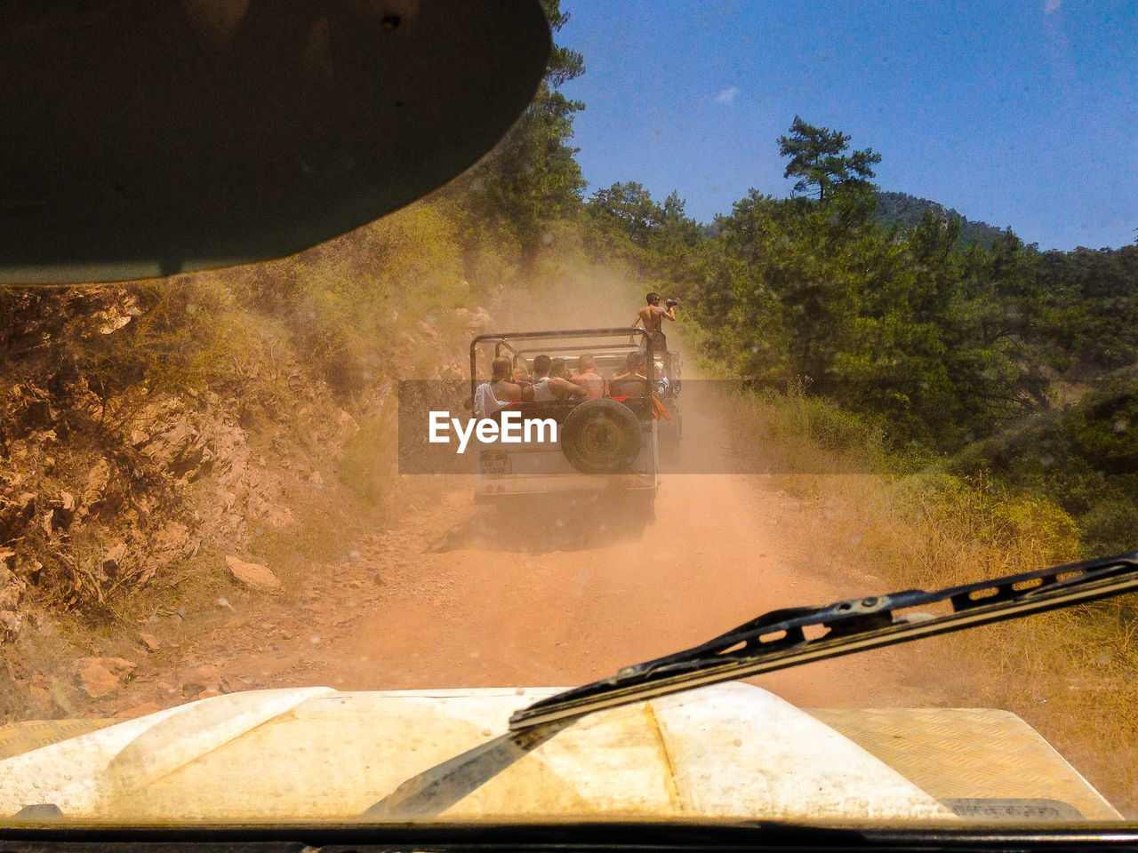 Vehicles running on dirt road