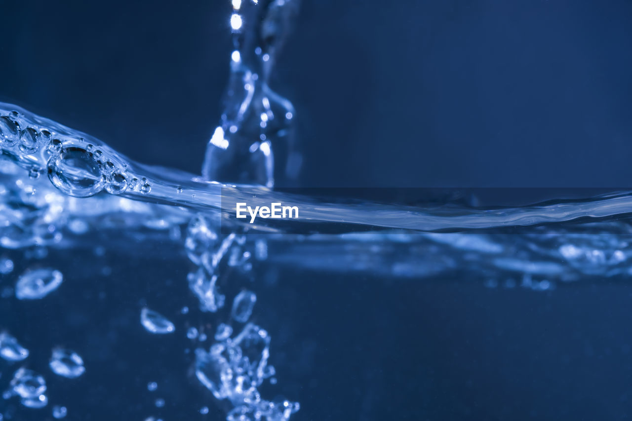 CLOSE-UP OF WATER DROPS ON ICE