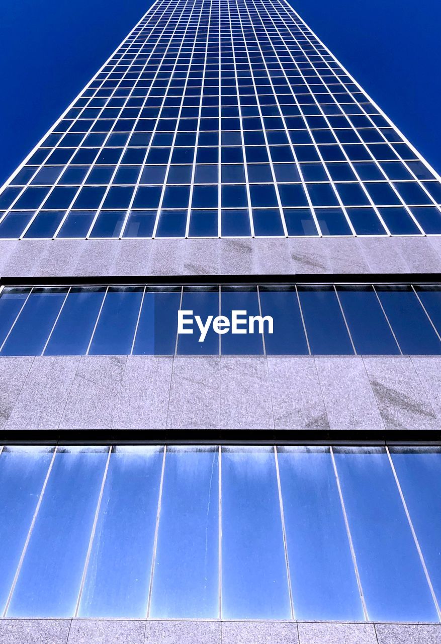 LOW ANGLE VIEW OF BUILDING AGAINST BLUE SKY