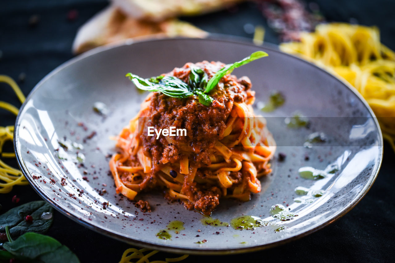 Tasty spaghetti bolognese with fresh basil