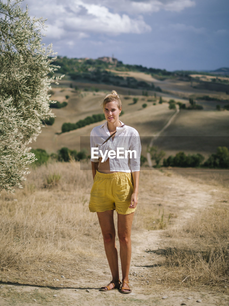 Rear view of woman walking on field