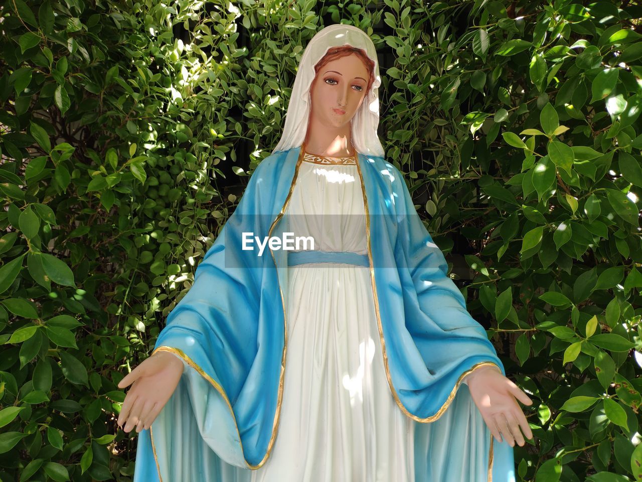 Virgin marry statue against trees