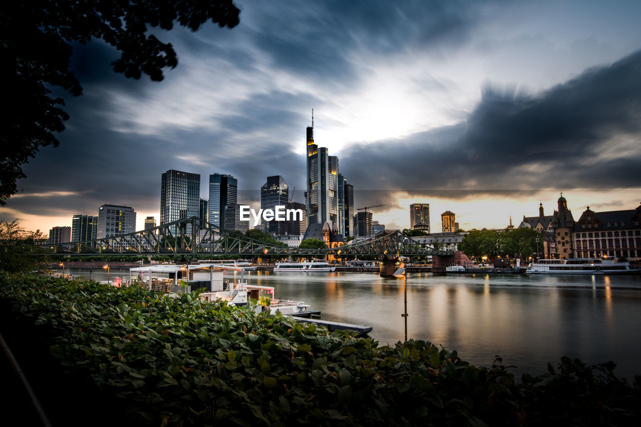 River with buildings in background in frankfurt, germany 