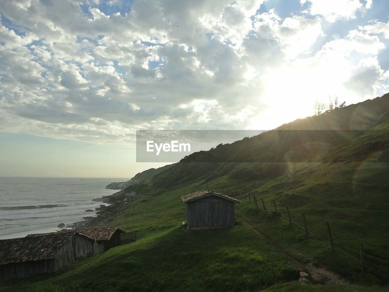 BUILT STRUCTURE BY SEA AGAINST SKY