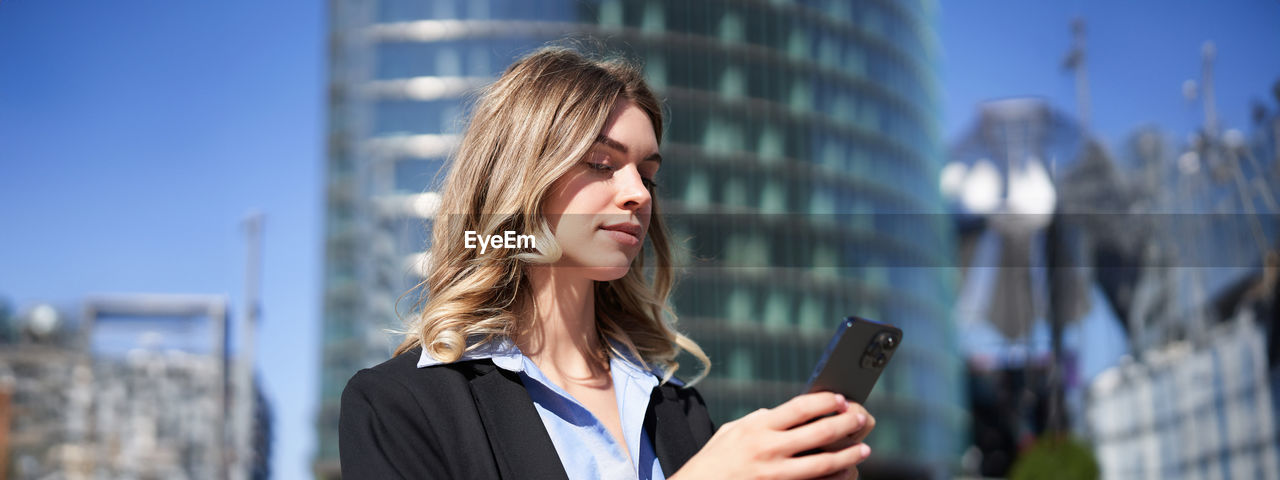 portrait of young woman using mobile phone