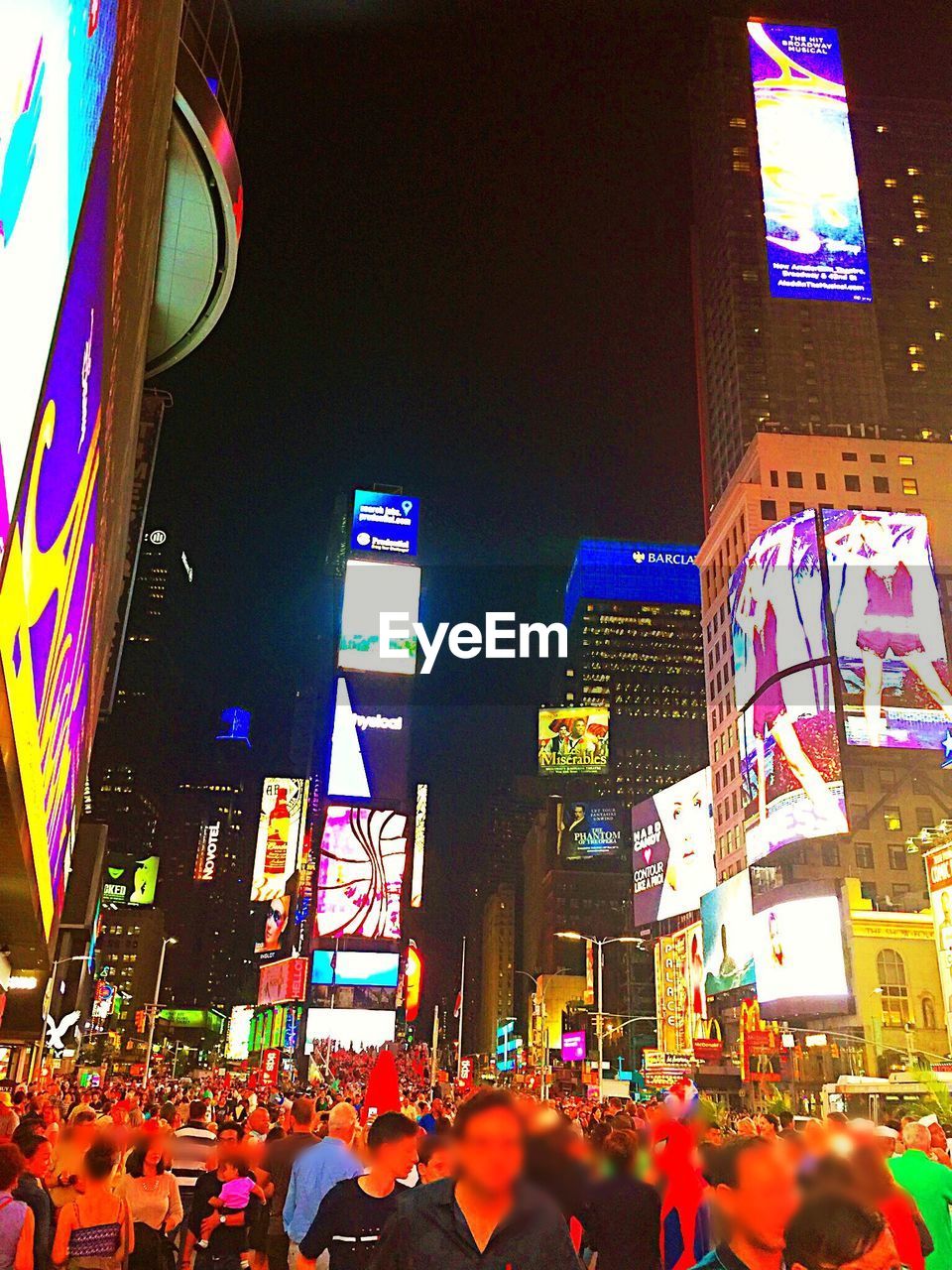 VIEW OF ILLUMINATED CITY AT NIGHT