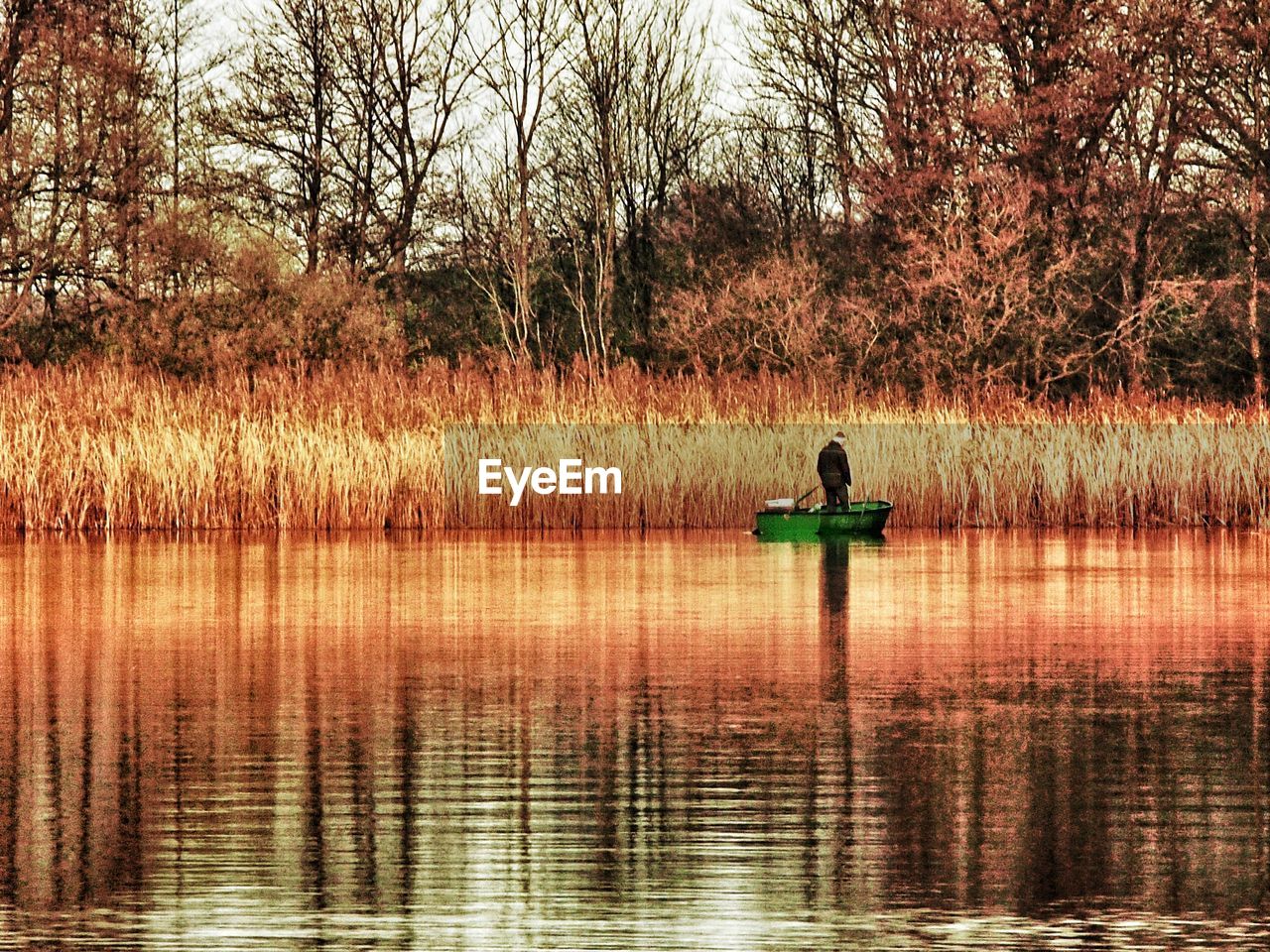 Man standing in rowboat