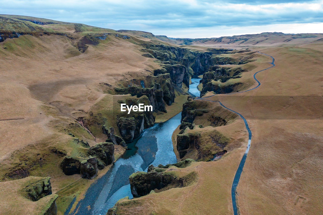 Wide estuary between hills in iceland, winding blue river, stream. tourist picturesque landscape.