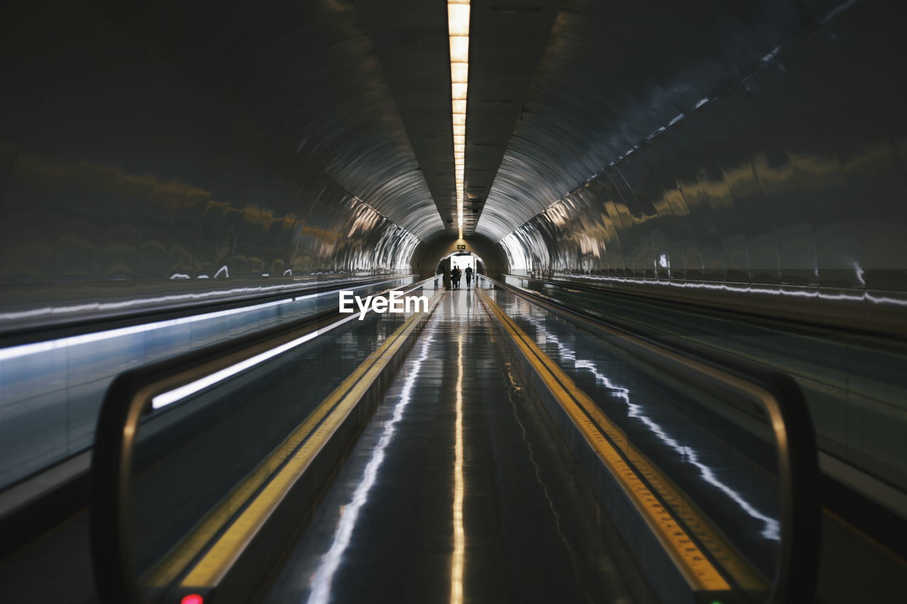 LIGHT TRAILS ON RAILROAD TRACKS IN TUNNEL