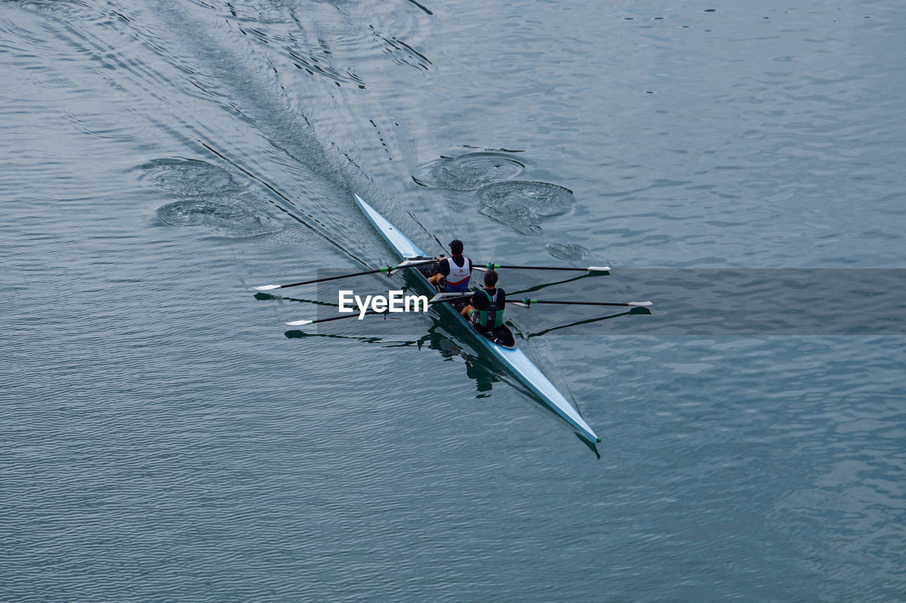 water, nautical vessel, rowing, transportation, sports, high angle view, teamwork, cooperation, nature, men, mode of transportation, group of people, oar, day, water sports, boating, adult, sculling, sport rowing, motion, competition, togetherness, outdoors, lake, waterfront, vehicle, beauty in nature, lifestyles