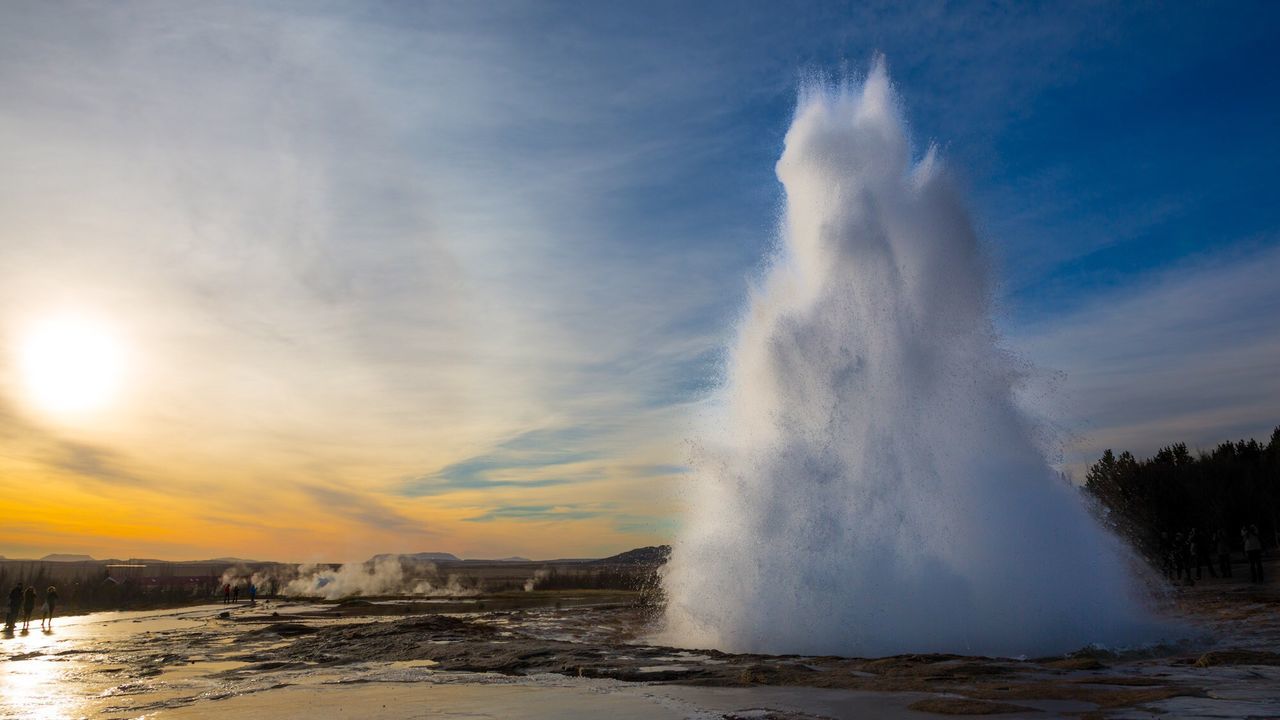 Strokkur against sky at sunset