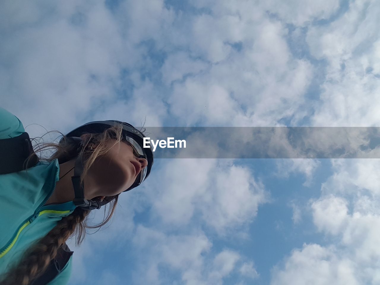 Low angle view of woman in sunglasses against sky