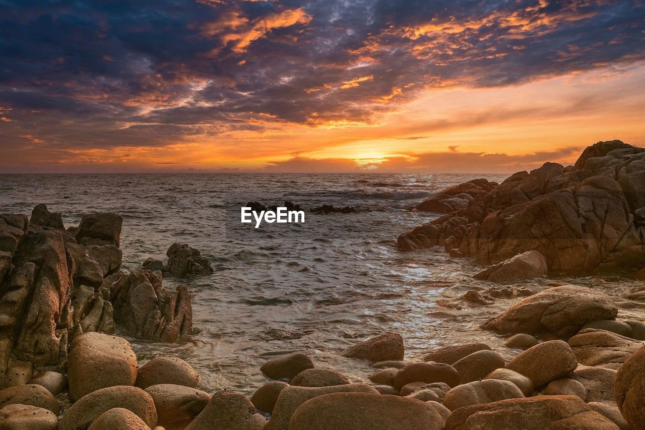 sea, sky, water, sunset, rock, land, beach, coast, shore, nature, scenics - nature, beauty in nature, cloud, environment, landscape, ocean, seascape, sun, travel destinations, travel, body of water, horizon, wave, horizon over water, coastline, no people, dawn, outdoors, sand, tranquility, motion, dramatic sky, evening, orange color, sunlight, trip, tranquil scene, tourism, holiday, vacation, summer, idyllic