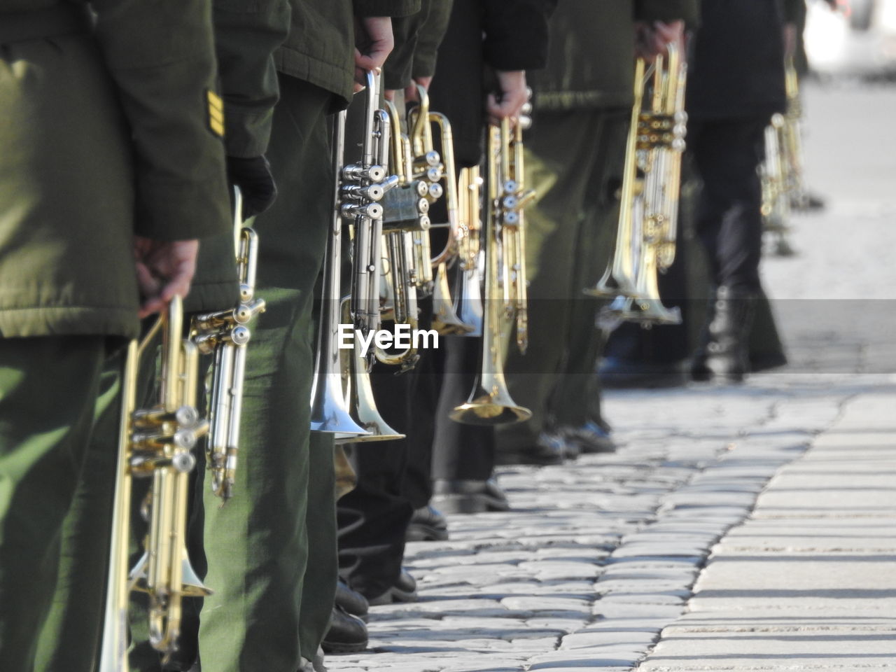 Men with musical instruments on footpath in city