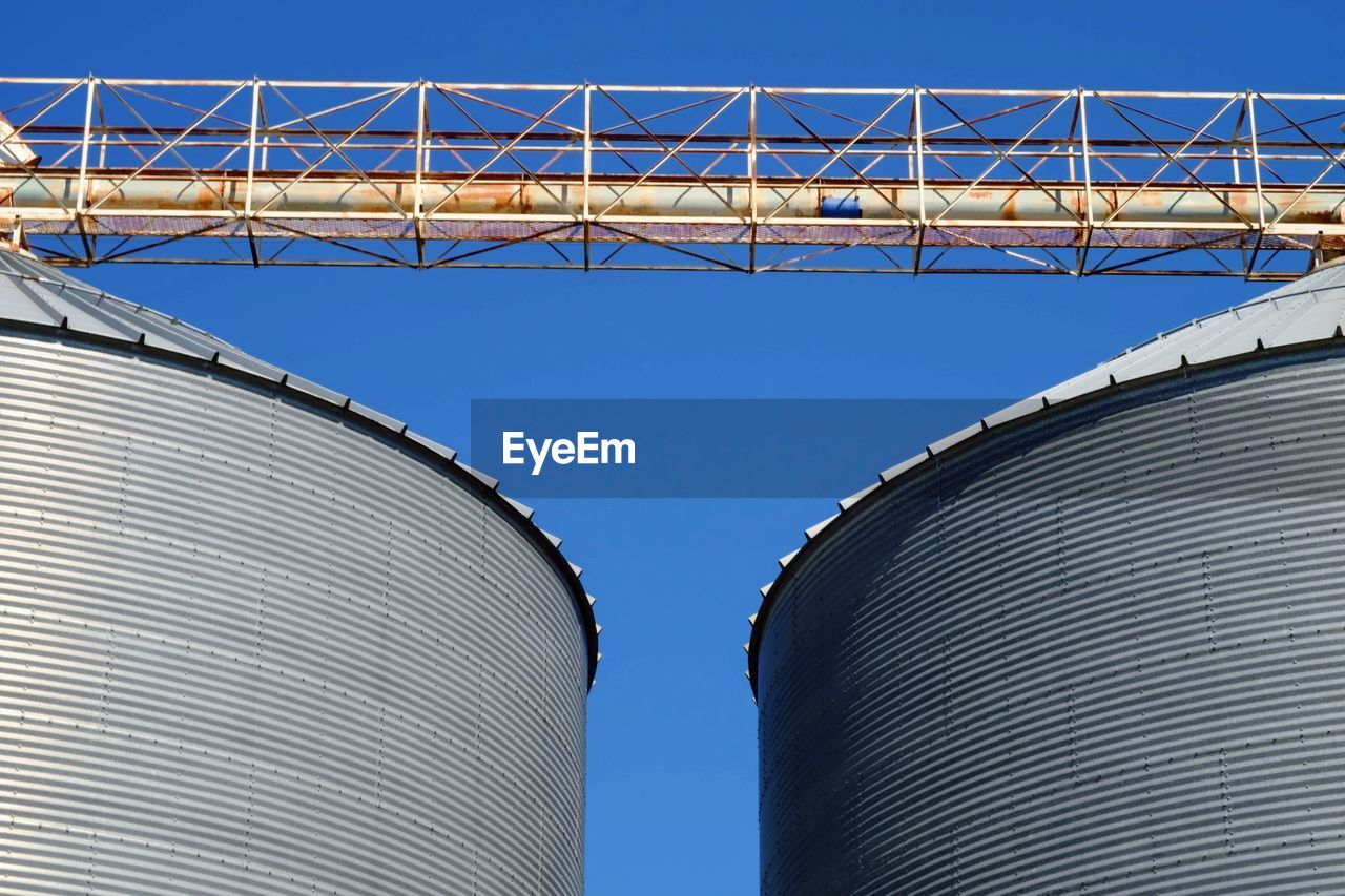 LOW ANGLE VIEW OF METALLIC STRUCTURE AGAINST SKY