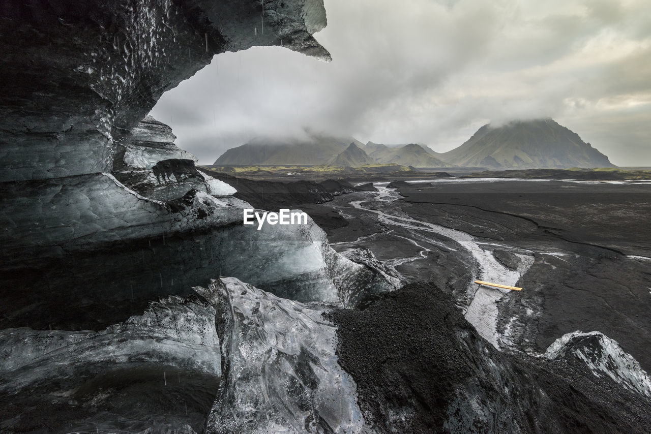 Panoramic view of rocks in lake against sky