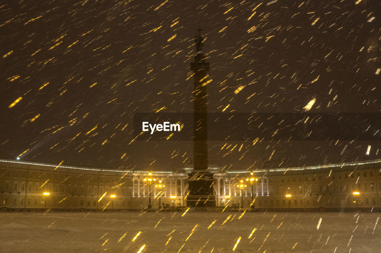 Monument at night during snowfall