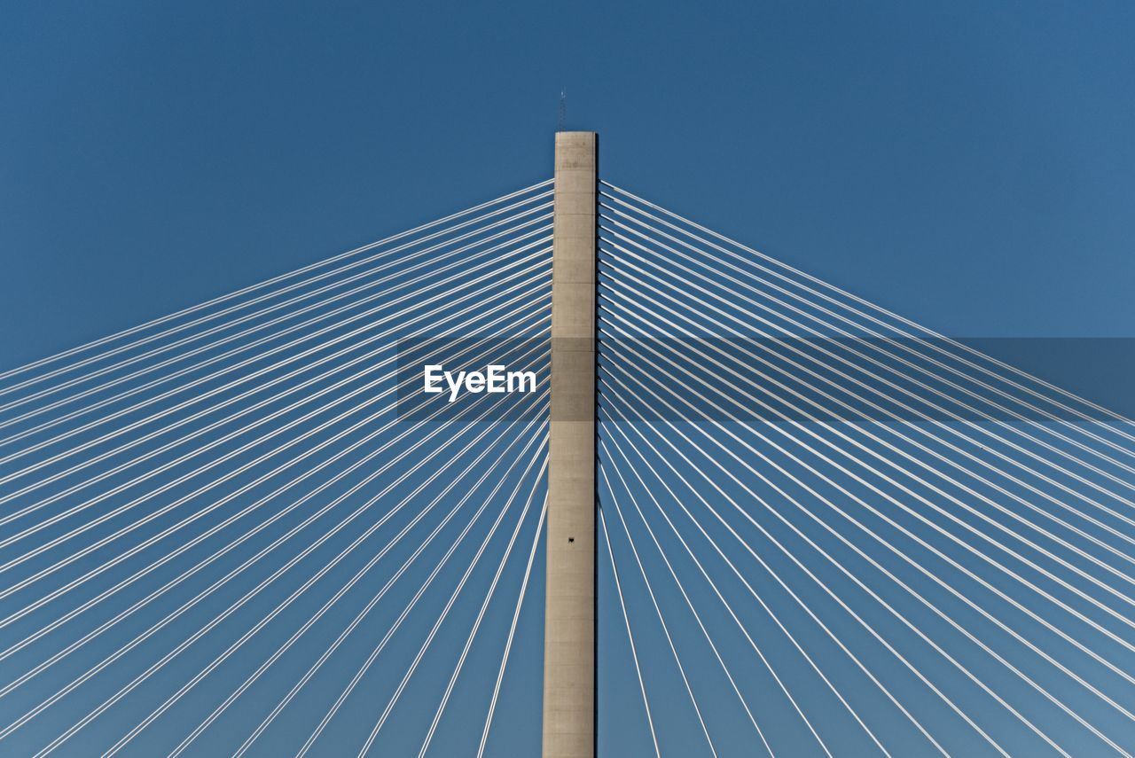 Low angle view of modern building against clear blue sky