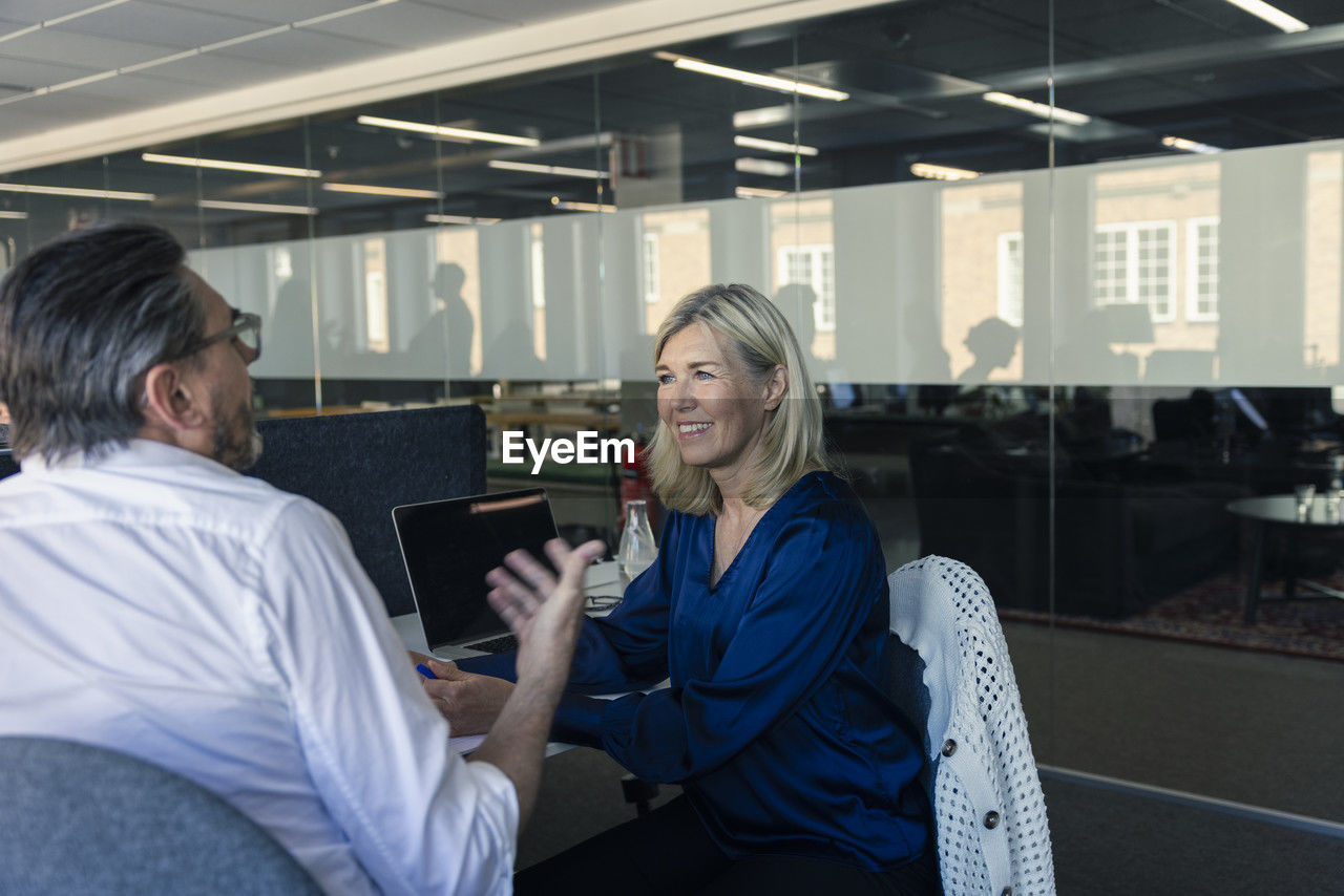 Two professionals discussing in office