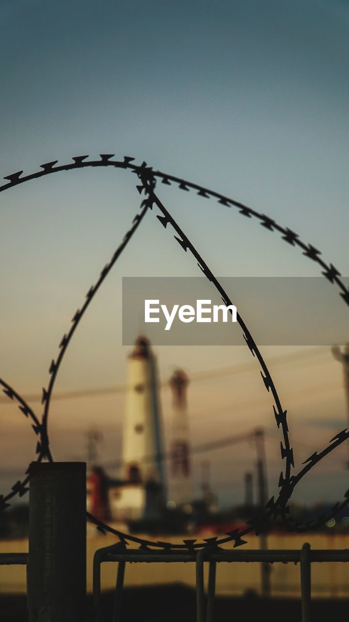 Low angle view of metal fence against clear sky in semarang, central java, indonesia 