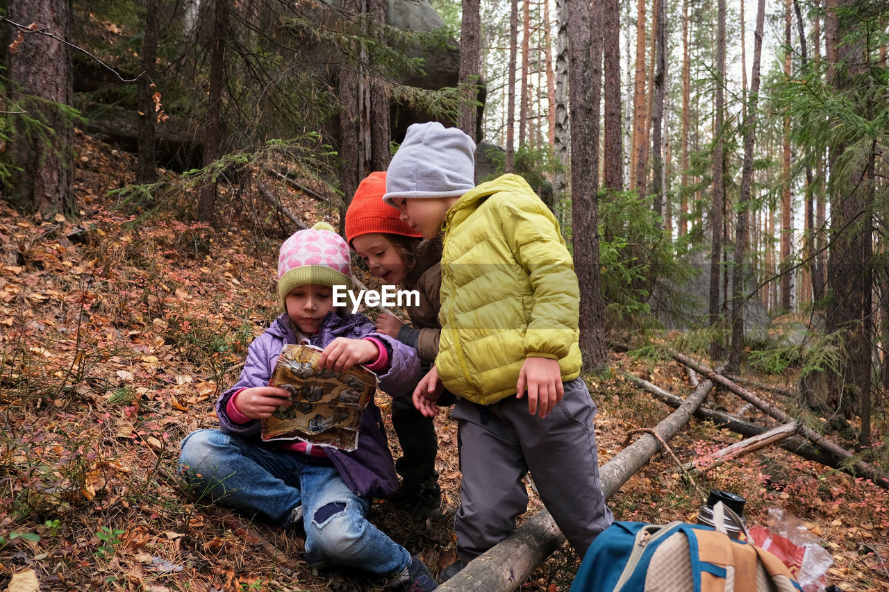 Children with map in forest