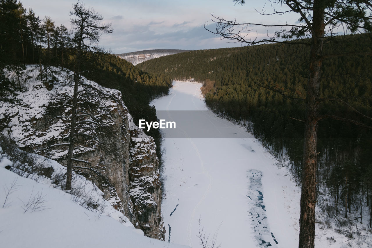 Scenic view of river against sky during winter