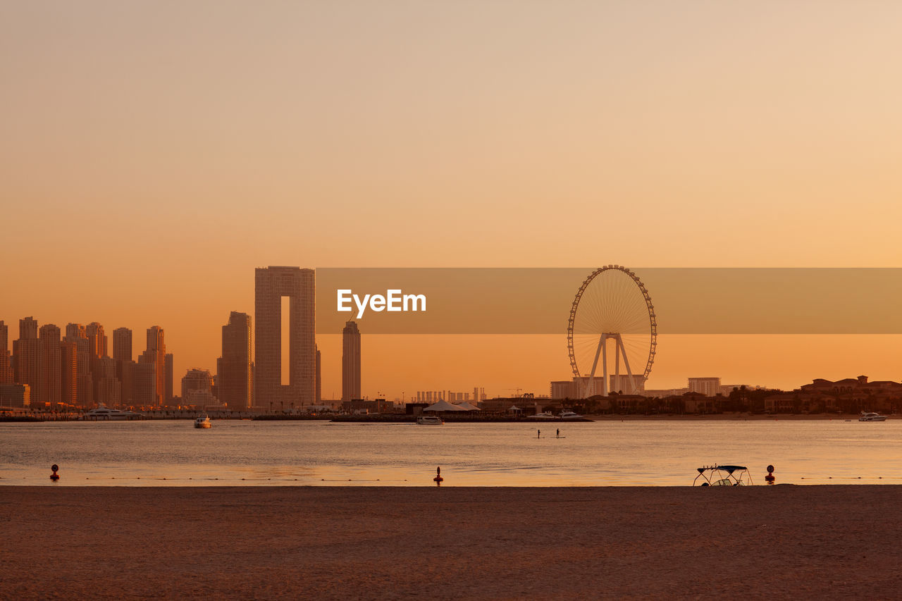 Sunset over the island of blue waters with the famous dubai eye ferris wheel