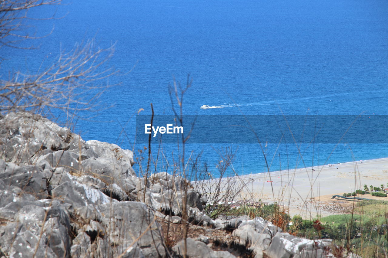 nature, plant, beauty in nature, no people, blue, water, day, scenics - nature, tree, tranquility, sky, rock, tranquil scene, land, mountain, sea, winter, outdoors, non-urban scene, clear sky, bare tree, beach, wilderness, geology, environment