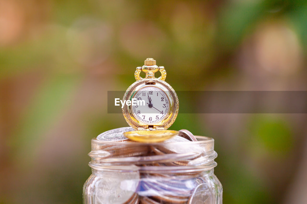 CLOSE-UP OF CLOCK IN JAR