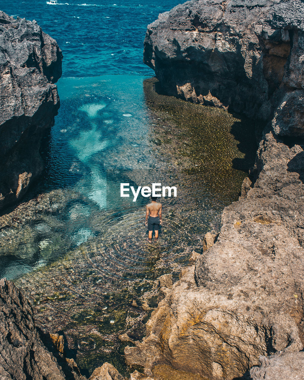 High angle view of man standing in sea